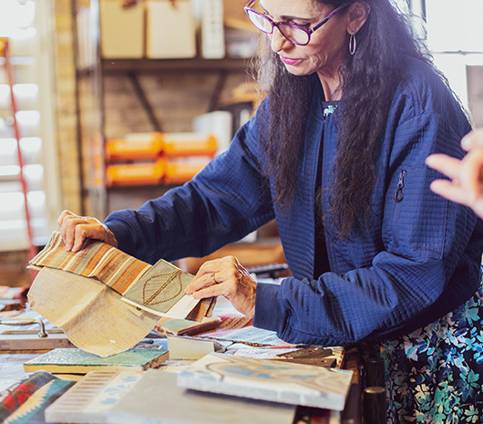 Sarah DeWitt holding up fabric samples