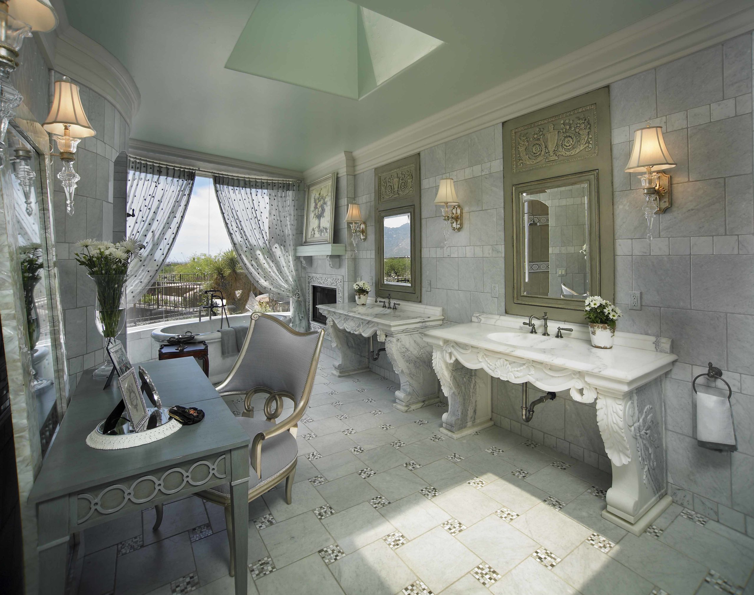 Bathroom with grey tiles on the floor and walls and white marble vanities