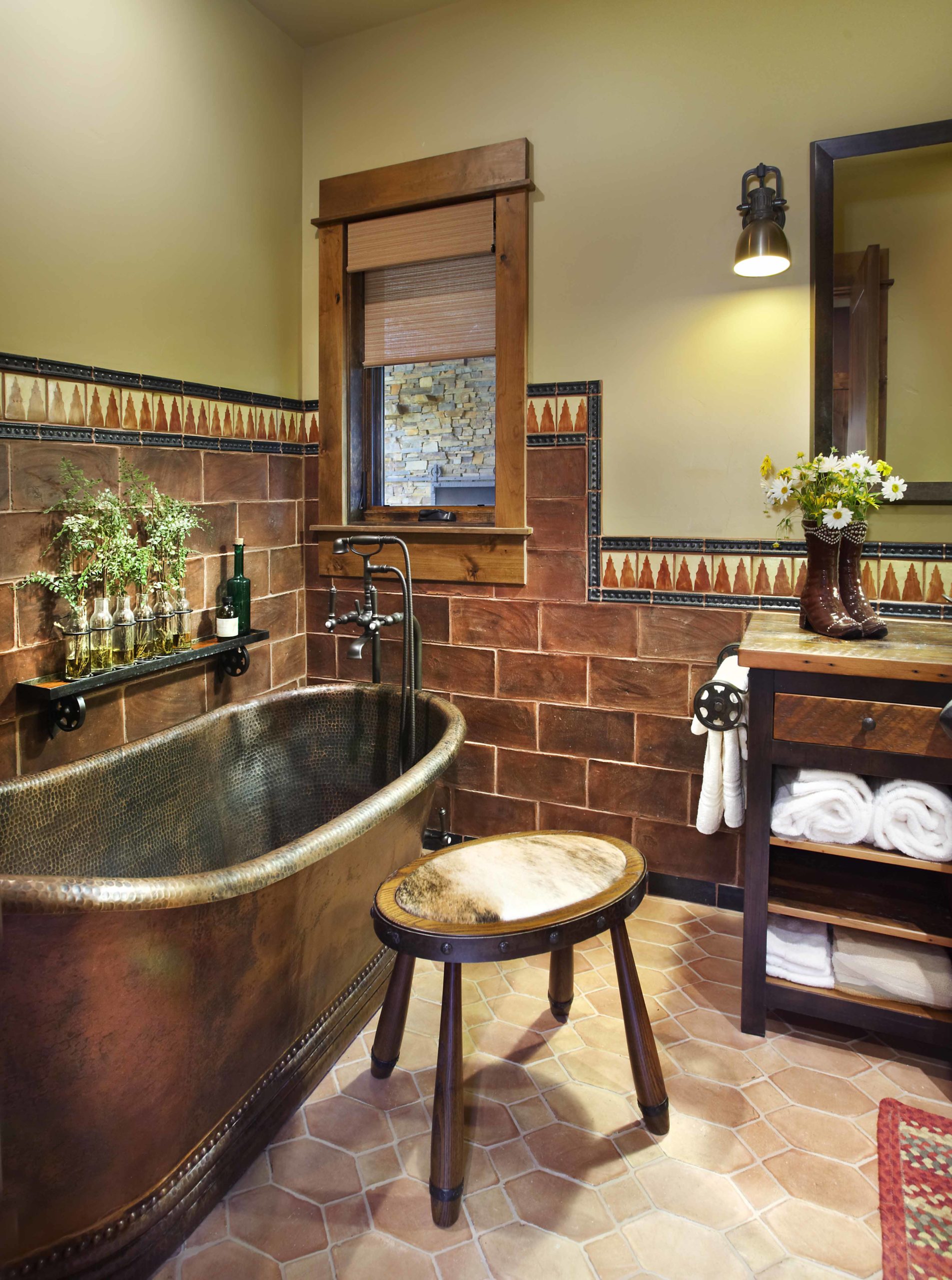 Bathroom with tiled floors and walls and a brown metal tub