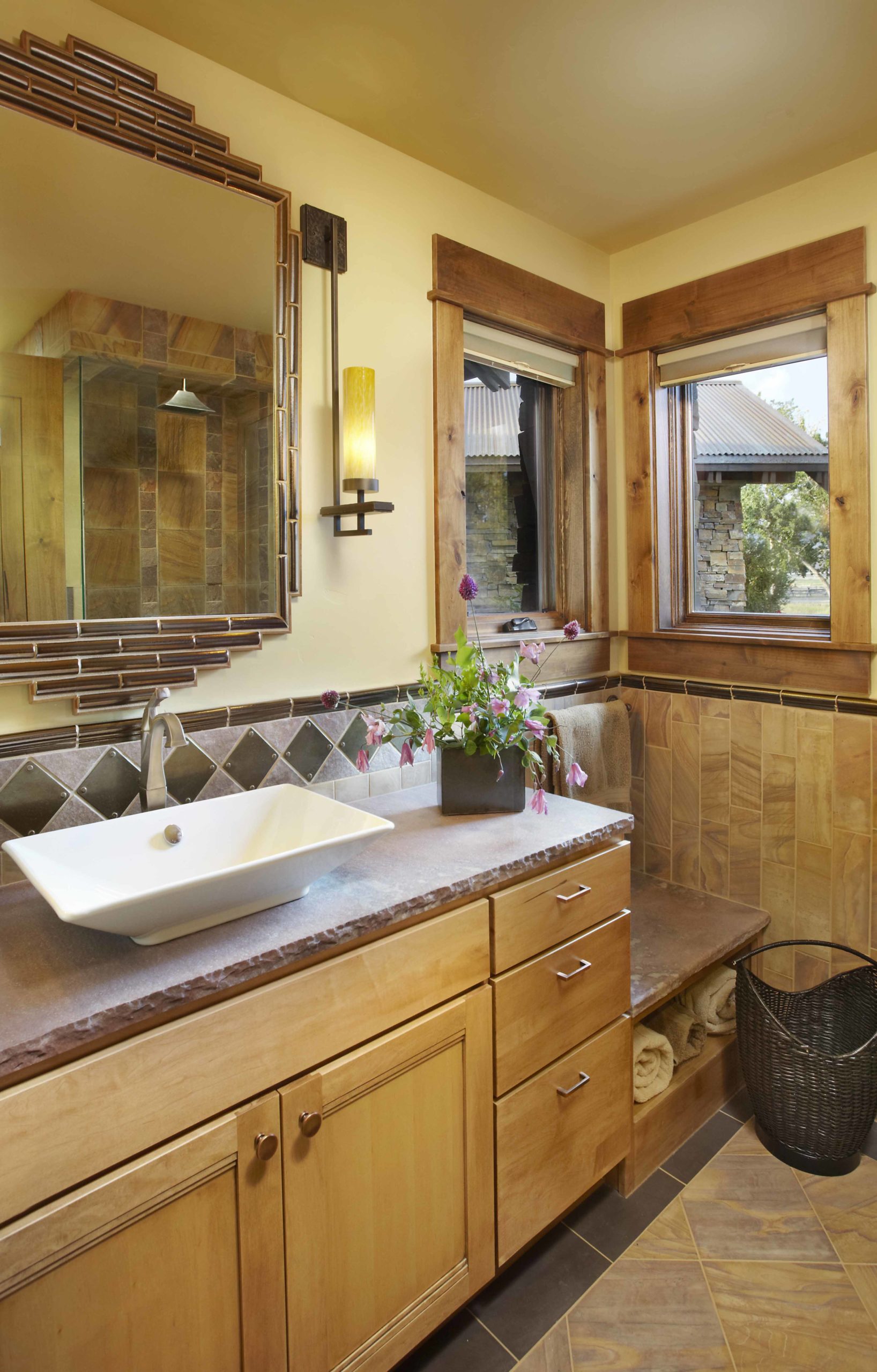 Bathroom with yellow walls and a light wooden vanity