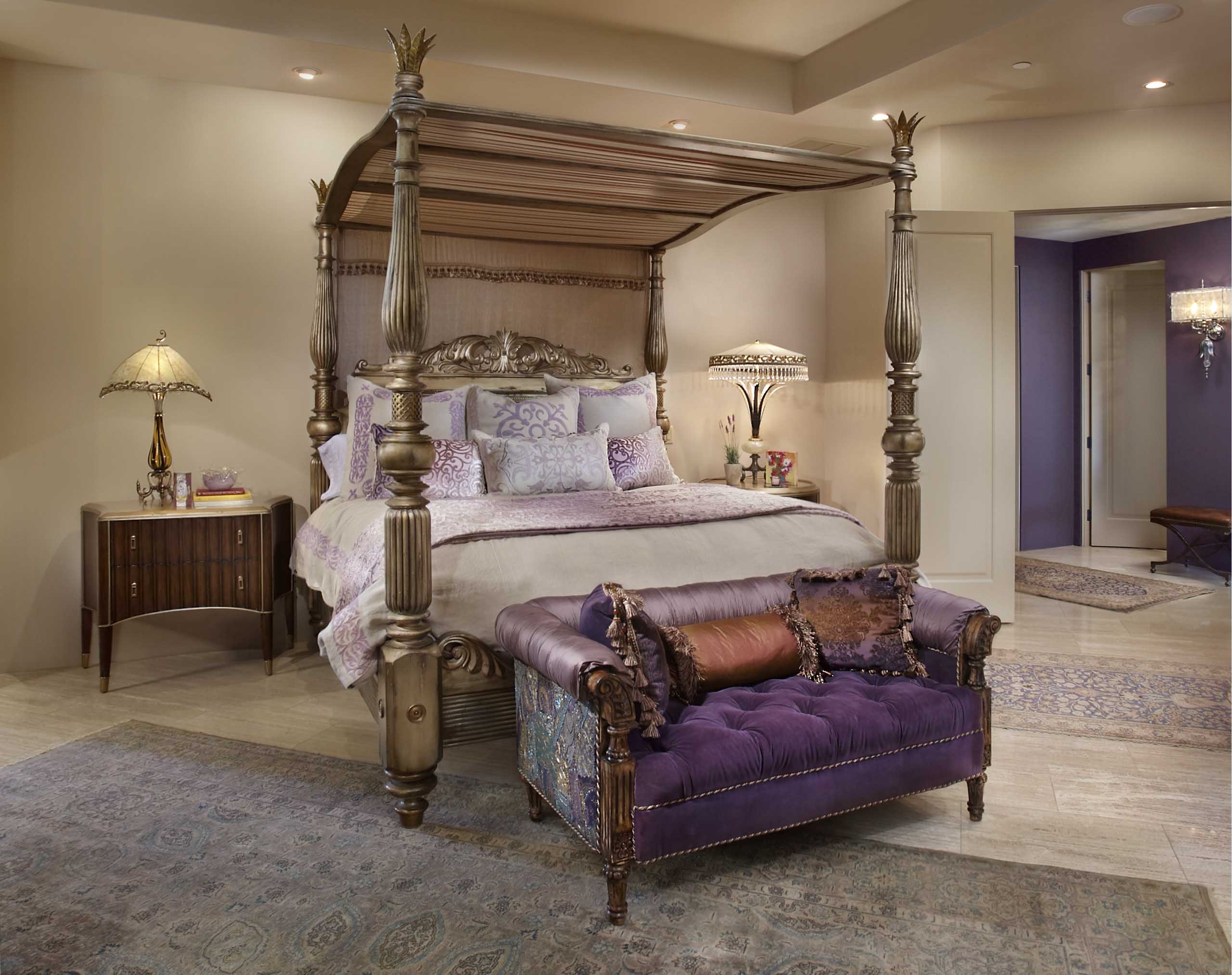 Bedroom with neutral walls, purple accents and a grand four-post bed frame