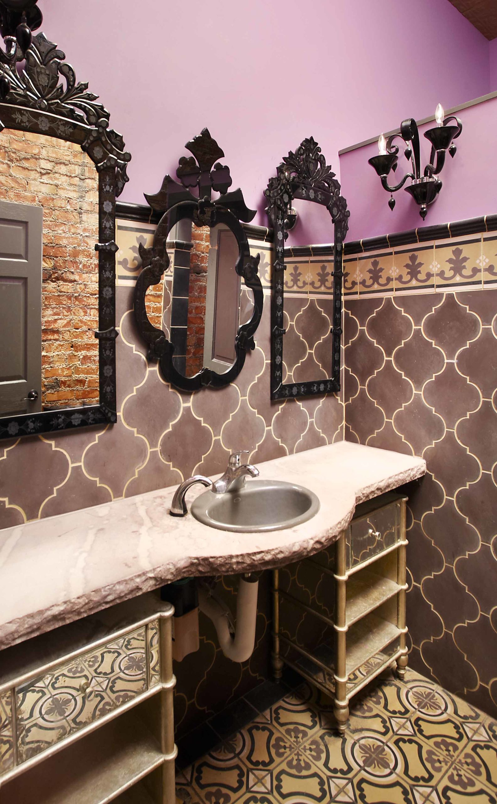 Bathroom with mixed tiles and grand mirrors