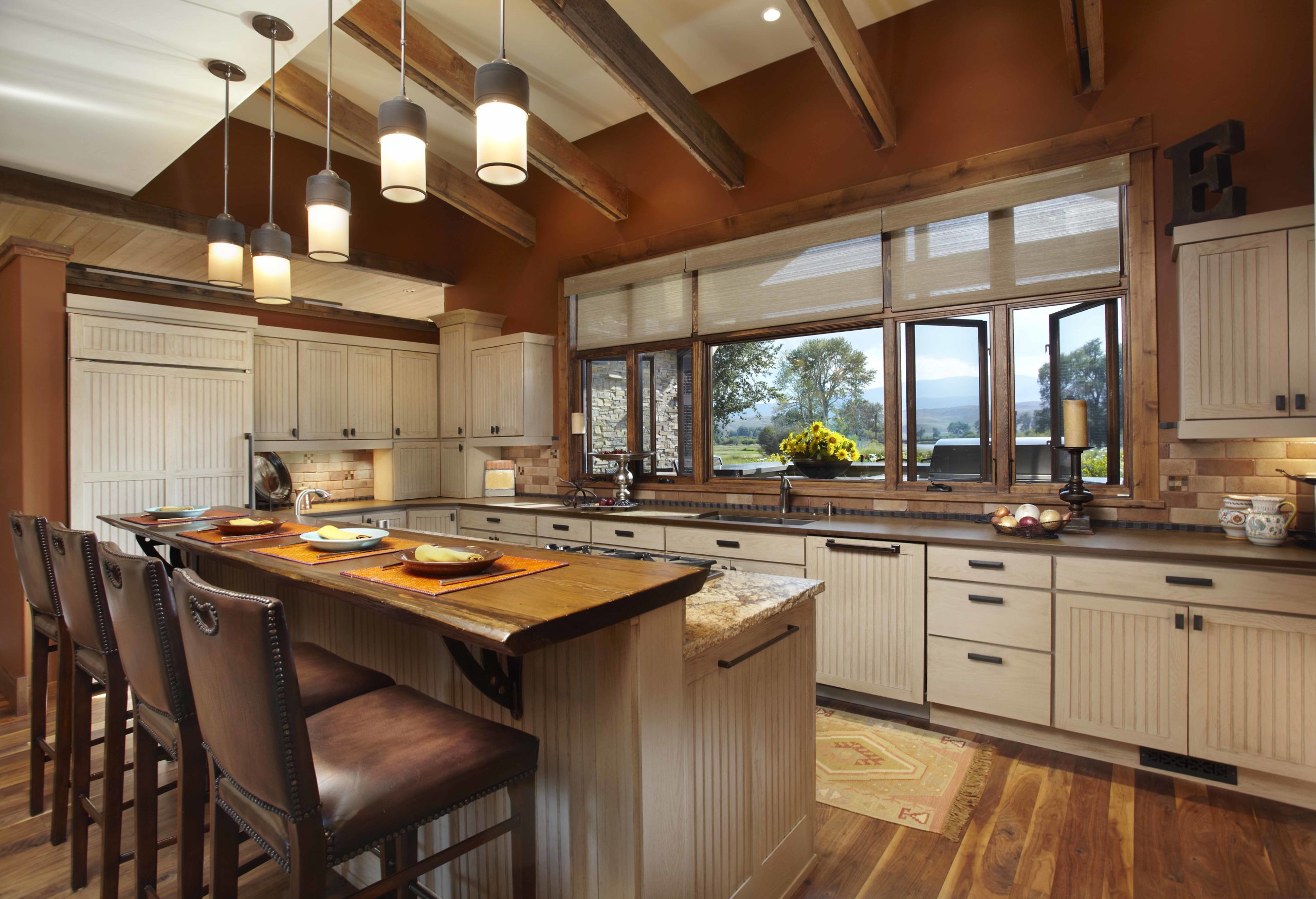 Kitchen with white washed cabinets, brown walls and dark wooden accents