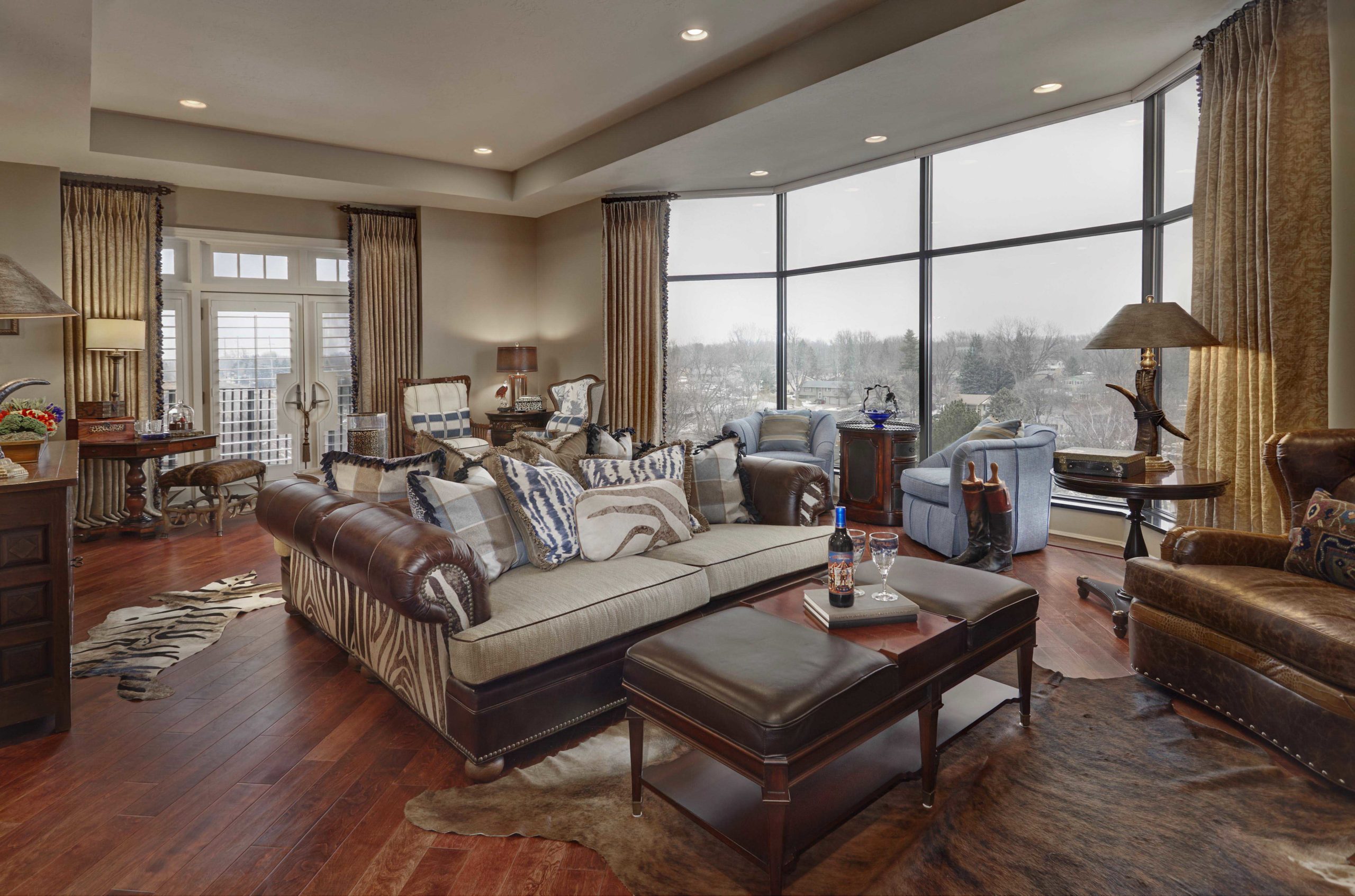 Large living room with dark wooden floors and animal print accents