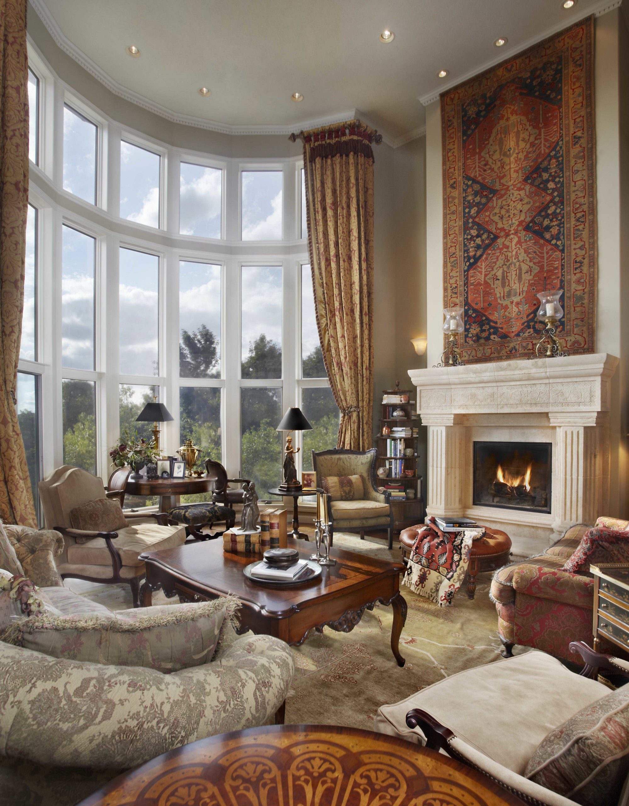 Bright living room with floor to ceiling windows and Persian accents