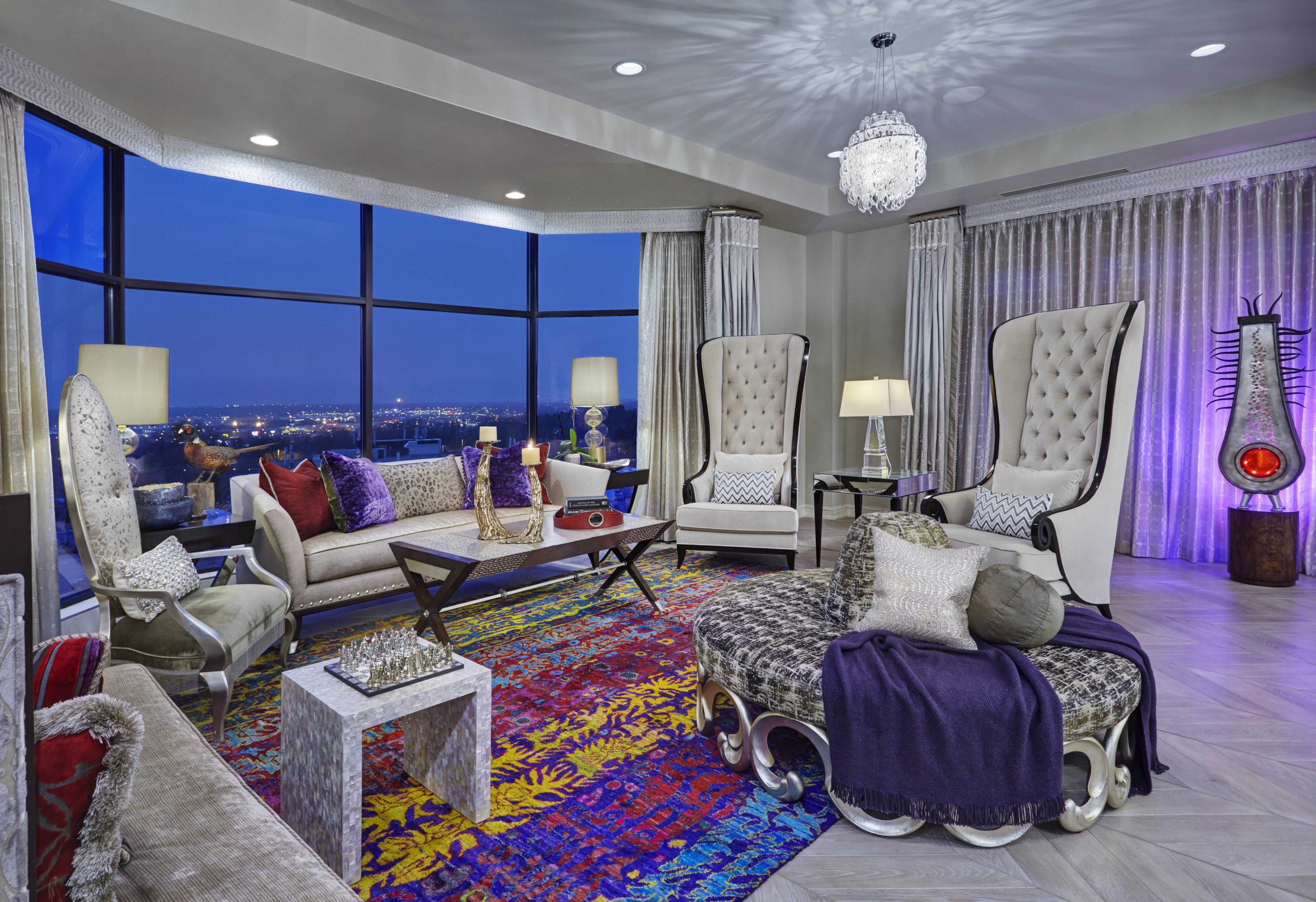 Living room overlooking a city scene with white walls, furniture and window coverings