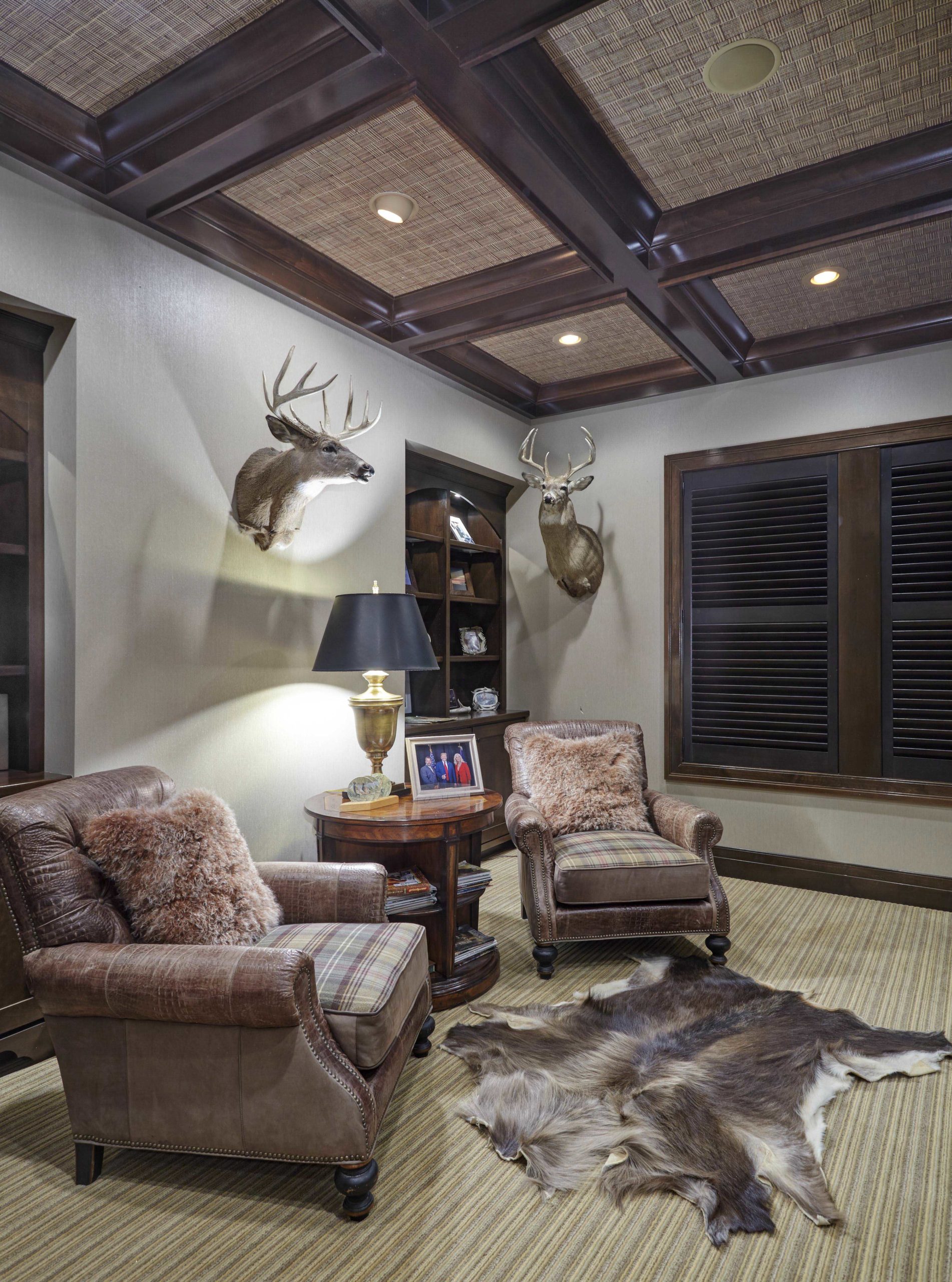 Brown leather chairs under deer heads
